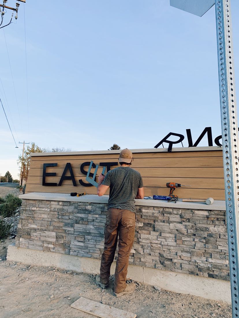 Peak Fabrication installing steel subdivision monument letters on site